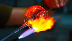 close-up of molten glass being worked by an artisan